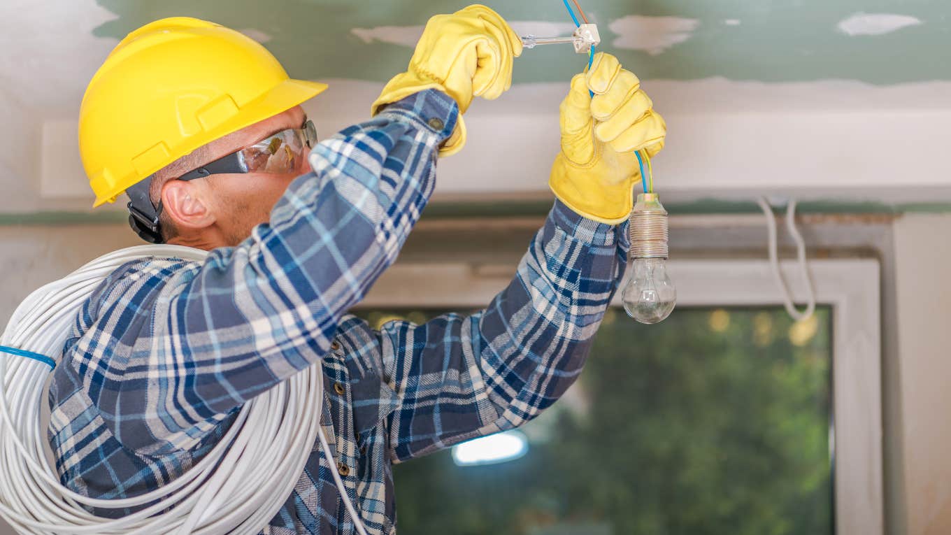 electrician in yellow hard hat working