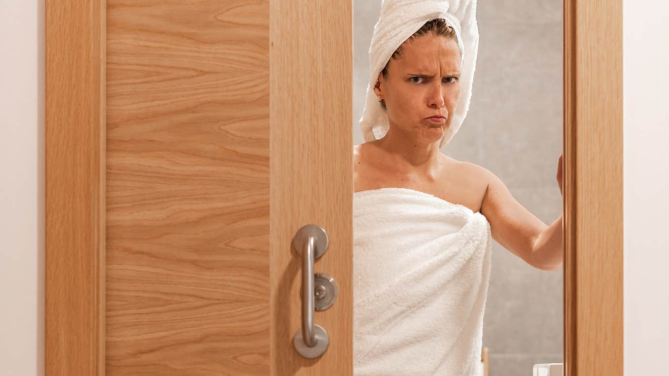 Woman Calls Out Mom Who Filmed Her Two Teen Sons Walking In On Her Using The Bathroom angry woman closing bathroom door