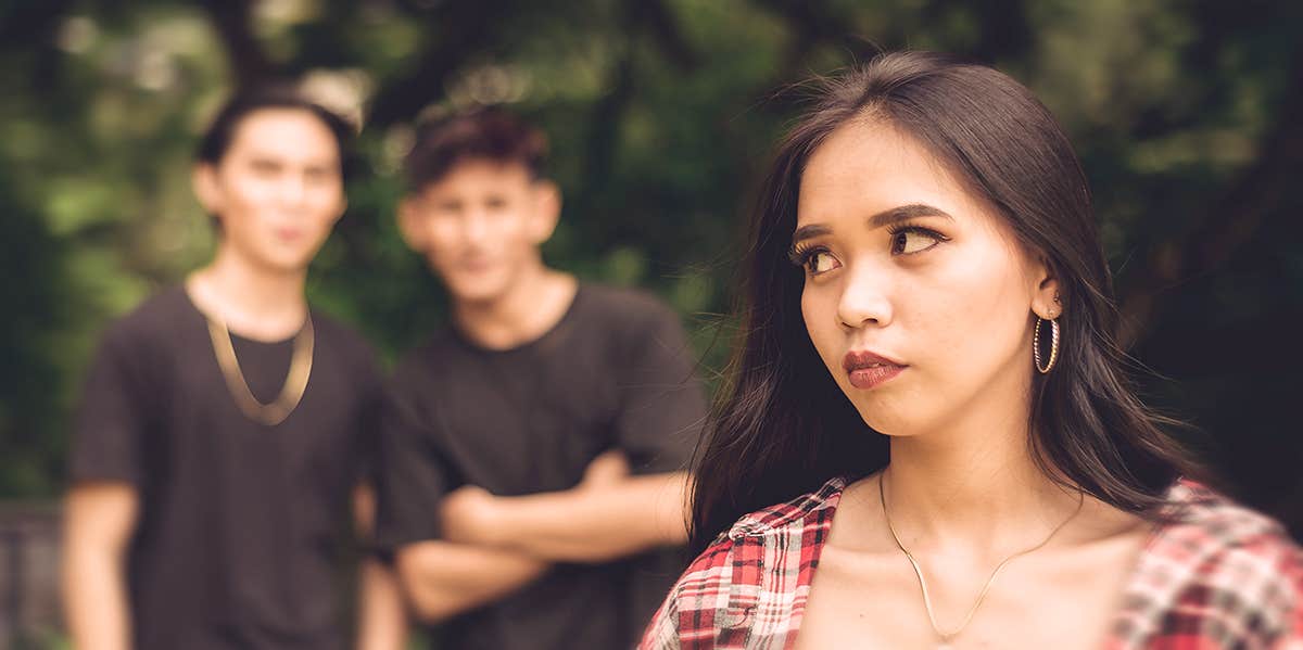 What It Really Means When A Man Catcalls You woman looks annoyed