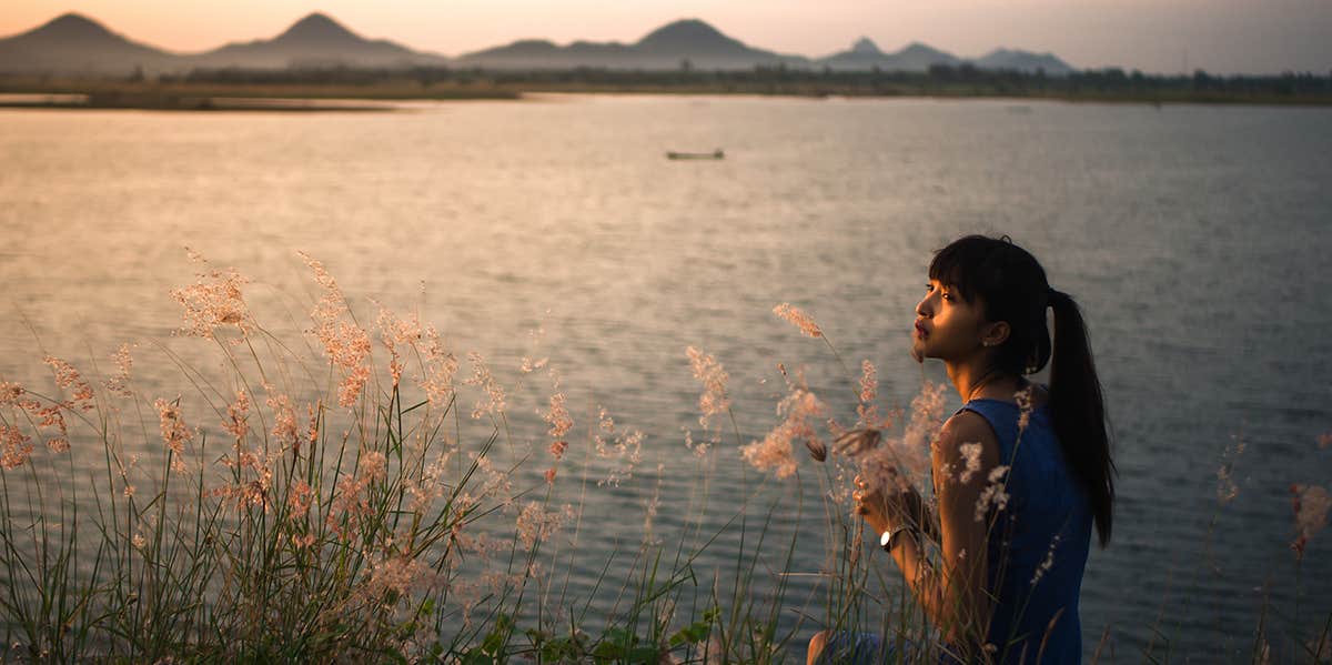 woman standing by lake