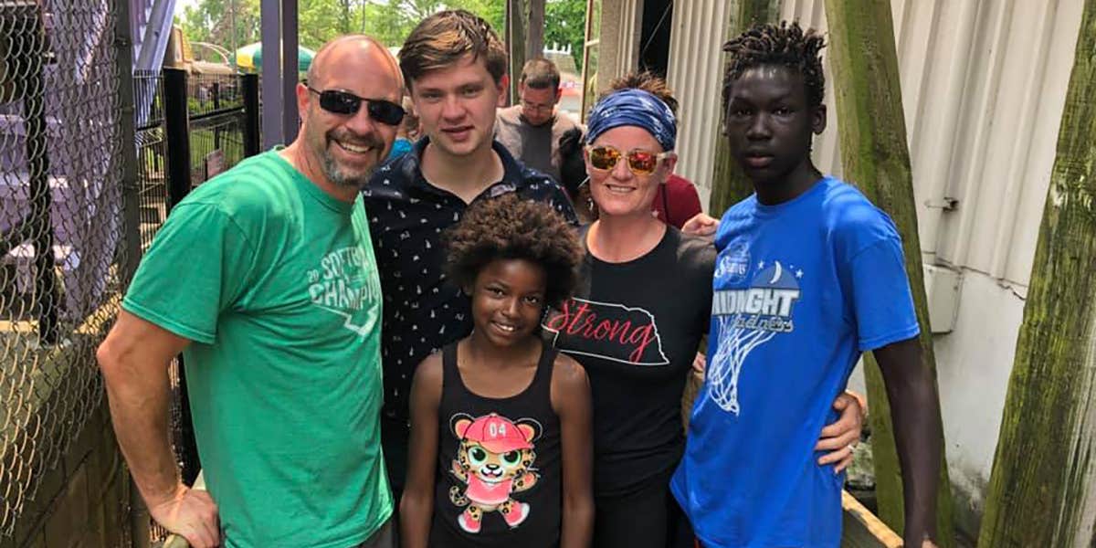 A photograph of the Coleman family outside together, posing for a picture.