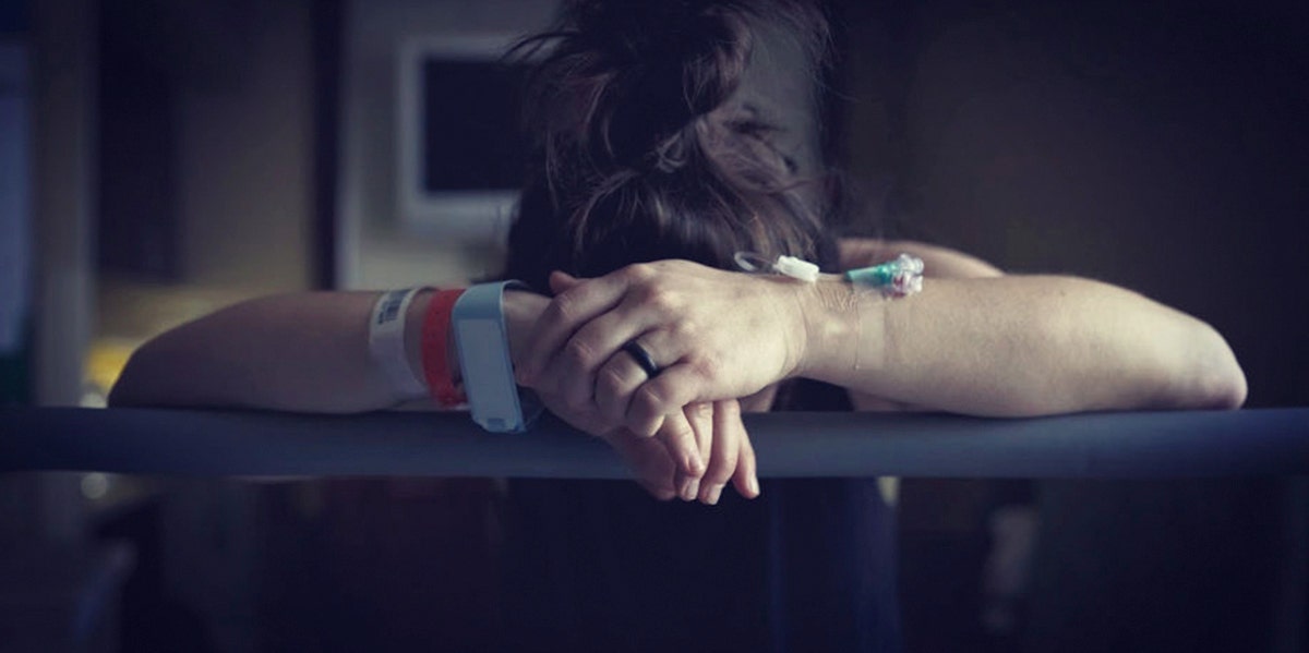 I'm A Mom Who Had An Abortion At 17 And It Still Haunts Me woman looking distraught on couch