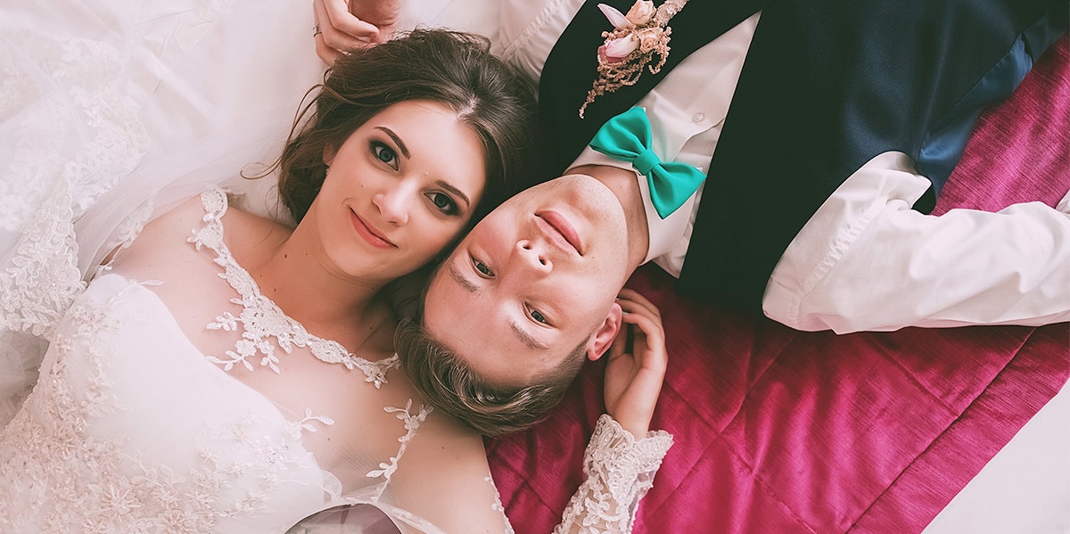 couple wedding laying down