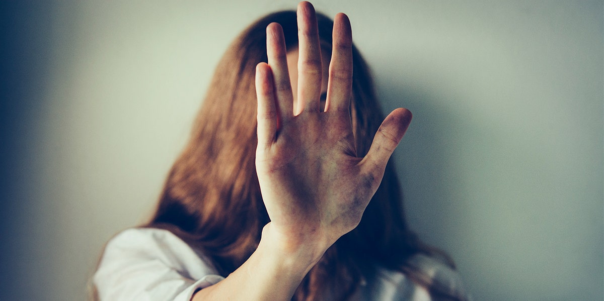 woman putting her hand to the camera