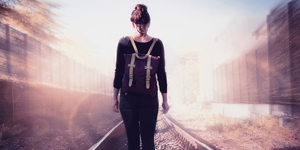 woman walking on train tracks