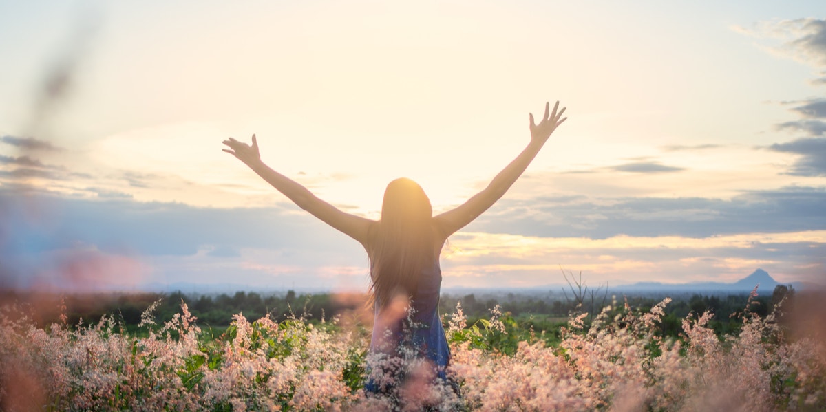 woman reaching out to sky