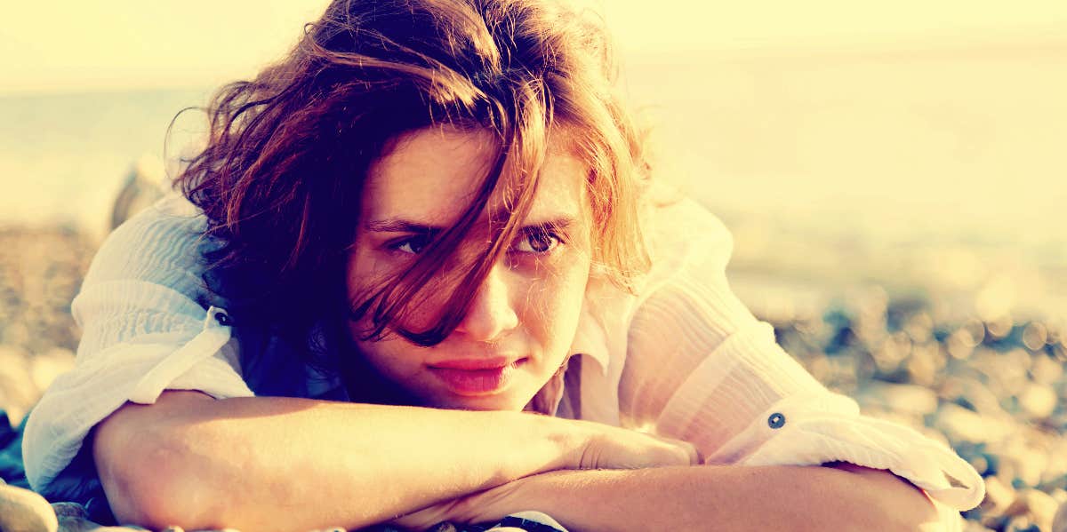Access inner medium contemplative woman on a beach