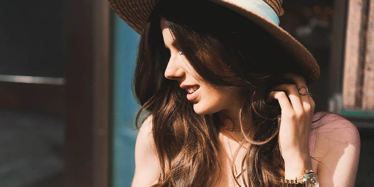 stylish woman wearing a hat and watch