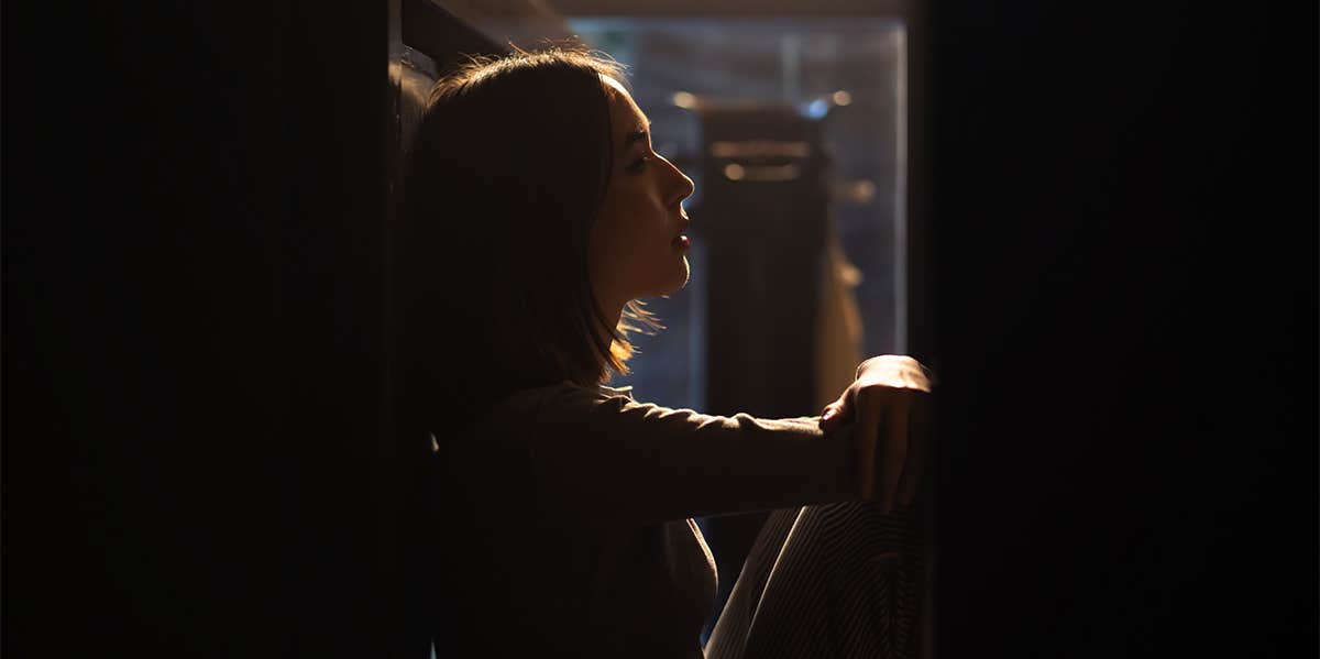 woman sitting in the dark
