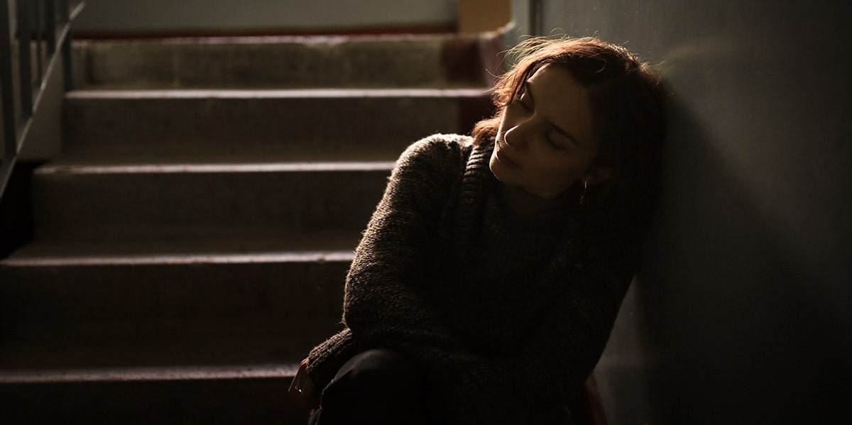 I'm Truly Terrified Of Telling My Partner About My Mental Health Issues sad woman sitting in the dark