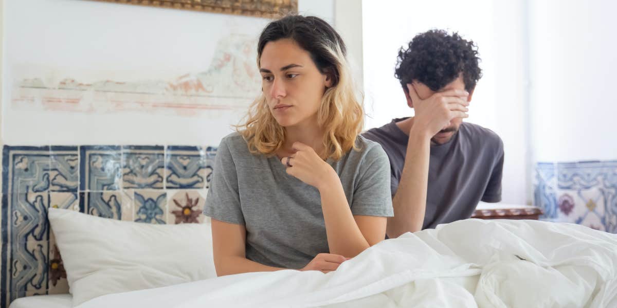 woman and man upset in bed