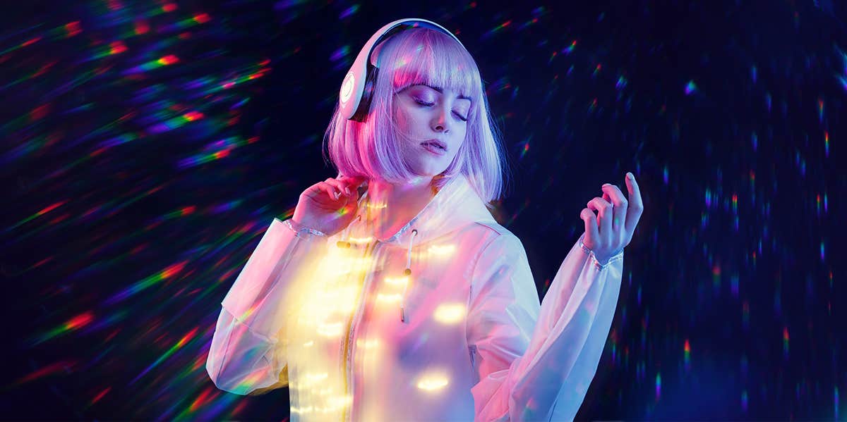 The Age When Your Music Taste Officially Gets Old, According To Research woman dancing listening to music in headphones