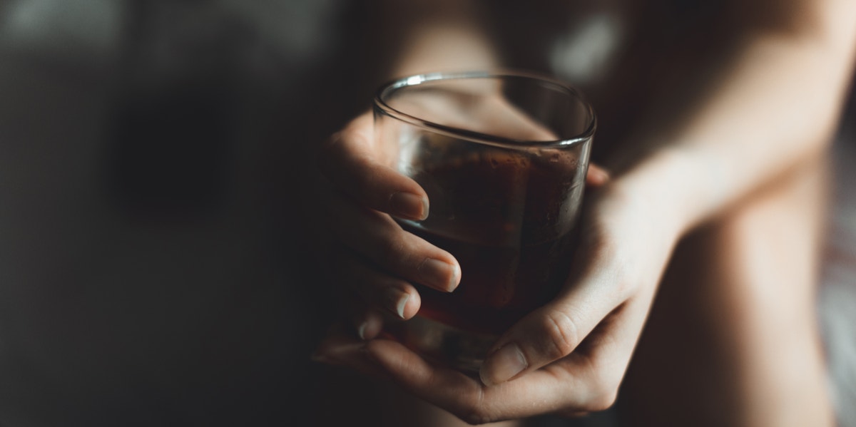 Woman holding glass of alcohol