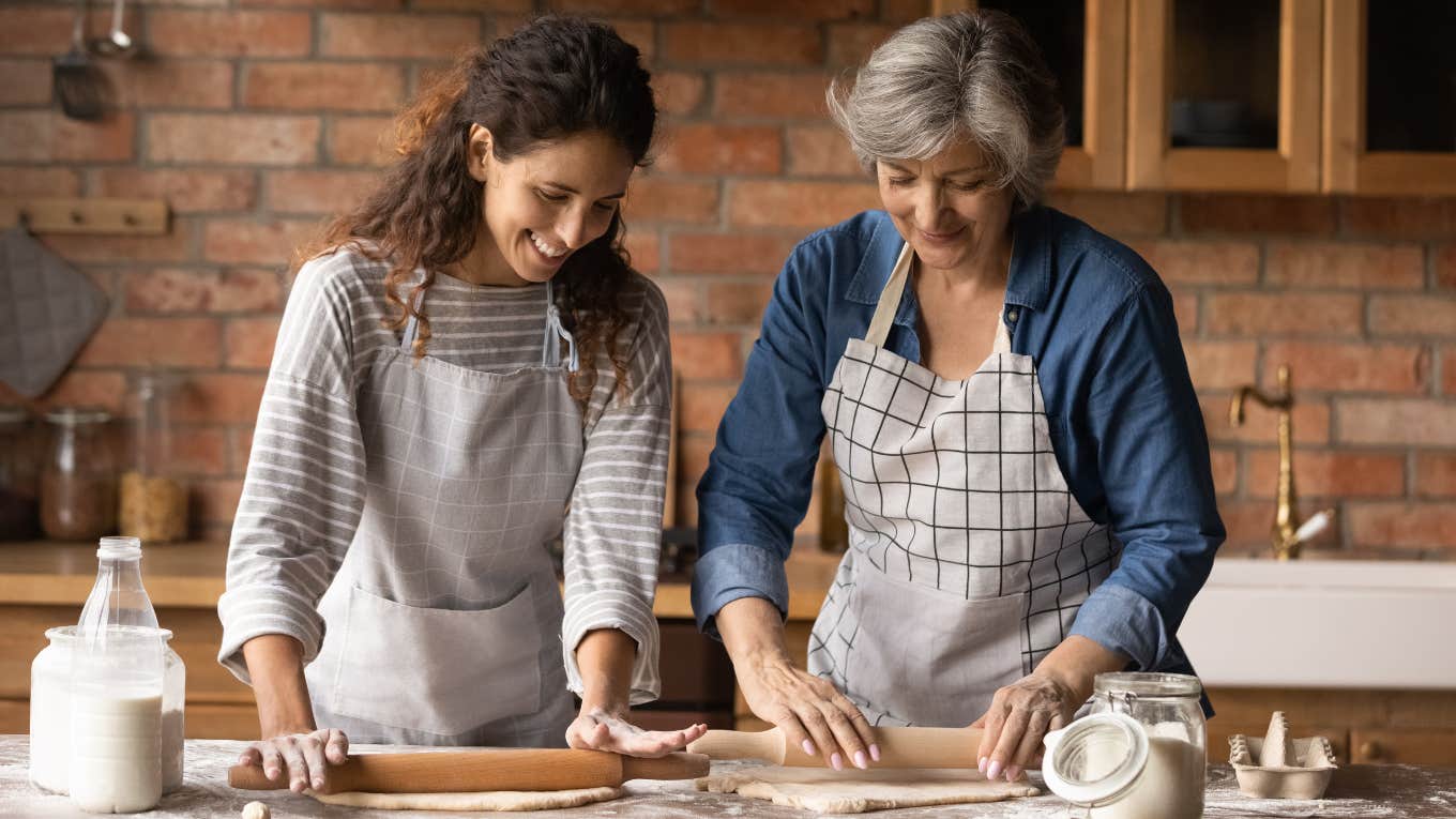 Mother and adult daughter baking in the kitchen.