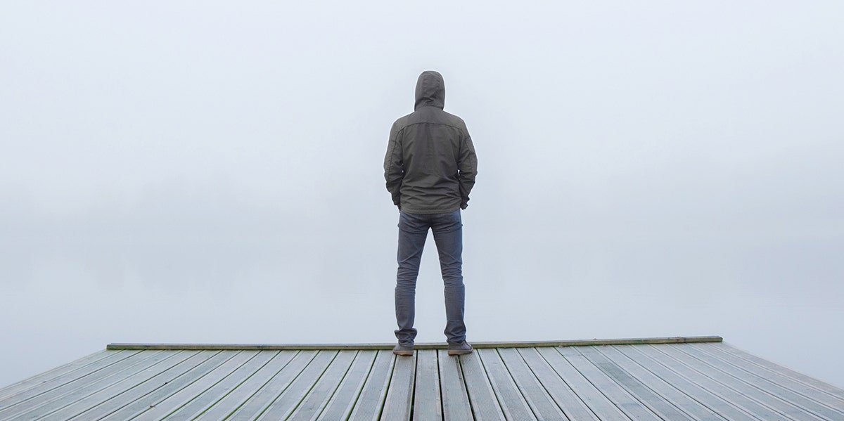 man standing alone on dock
