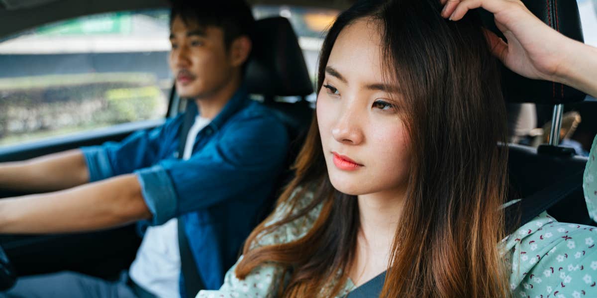 woman thinking in car with boyfriend