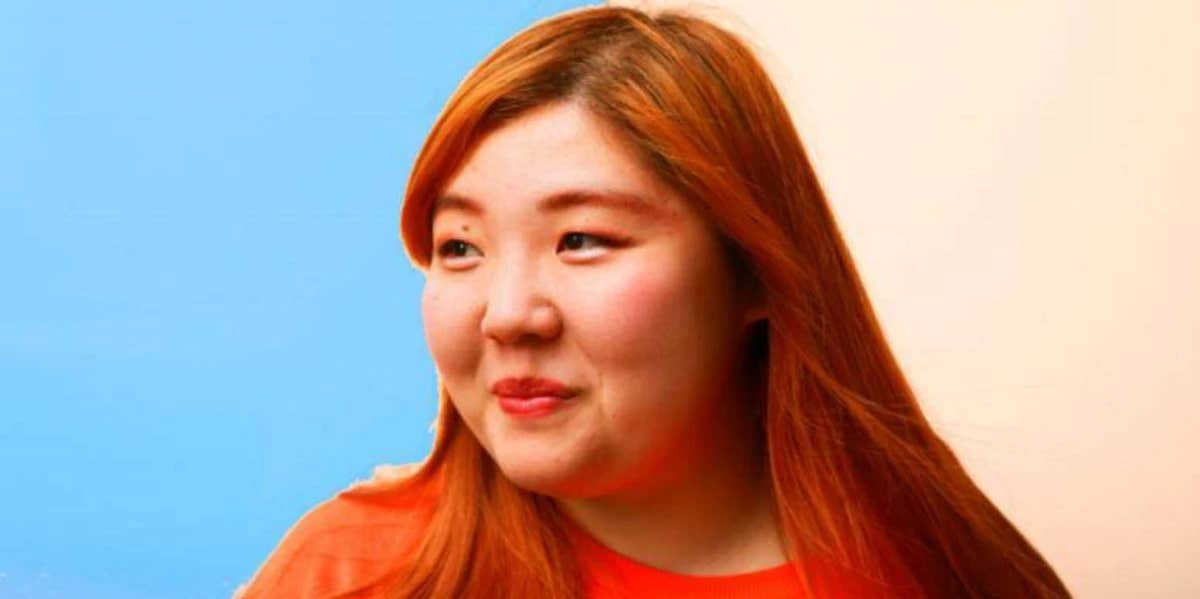 Am I Aromantic? How To Recognize The Signs woman with red hair split background blue and beige
