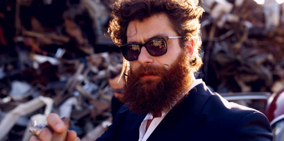 masculine guy with sunglasses and beard smoking cigar