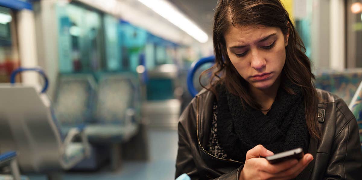 woman looking forlorn on phone