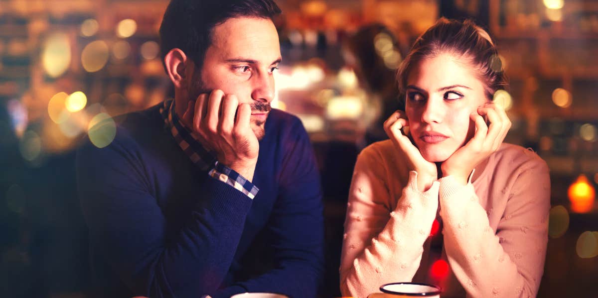 woman looking at unhappy man wondering if she's his second choice