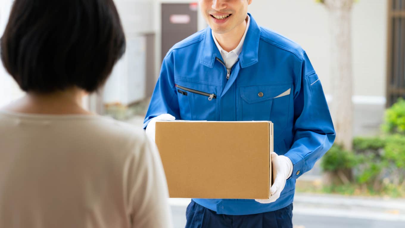 delivery driver handing customer package