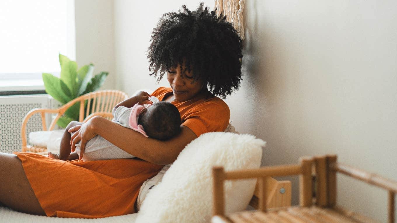 woman feeding baby a bottle