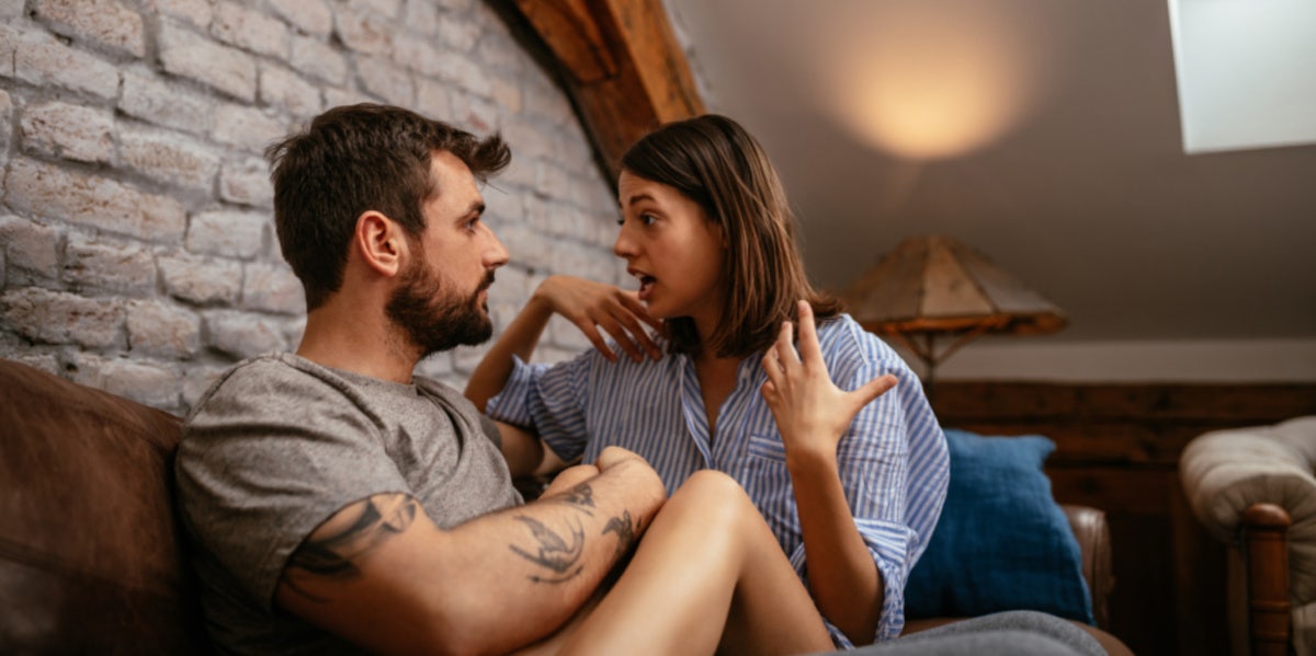 woman and man talking on couch