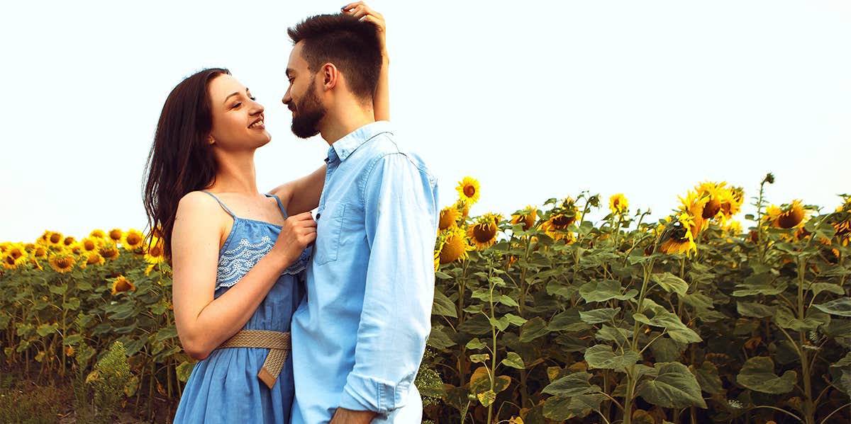 man and woman in sunflower field