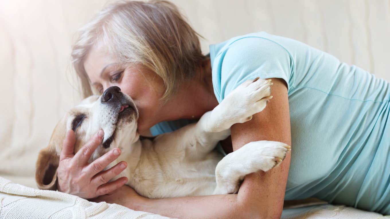 woman and dog snuggling