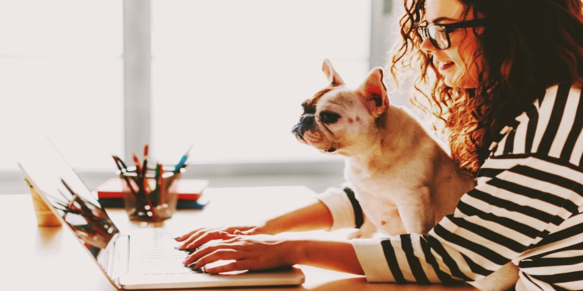 woman working at computer with dog