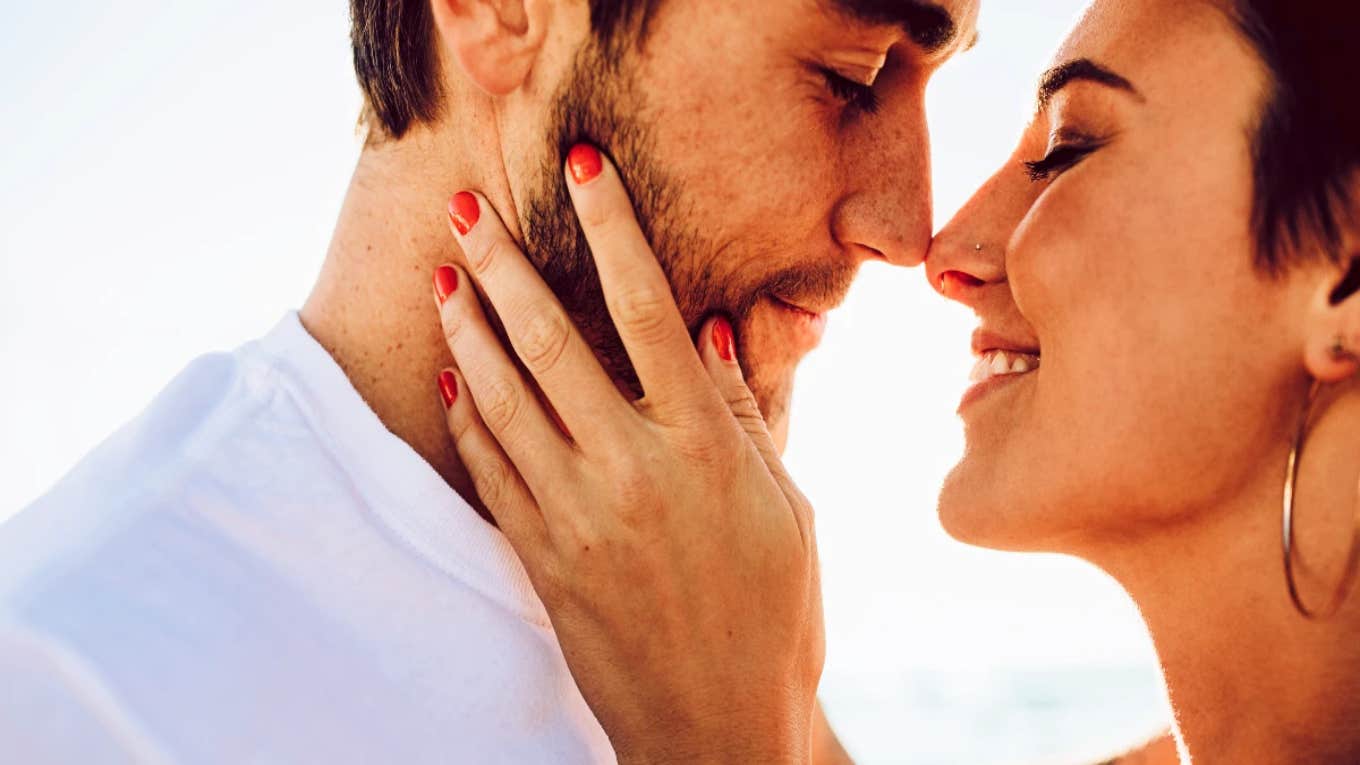 Why Couples Who Have The 'Same Old Fight' May Be Soulmates smiling couple about to kiss