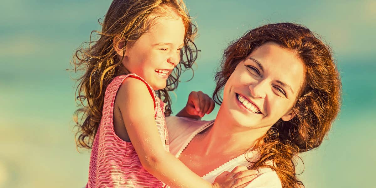 Happy mom and daughter on the beach