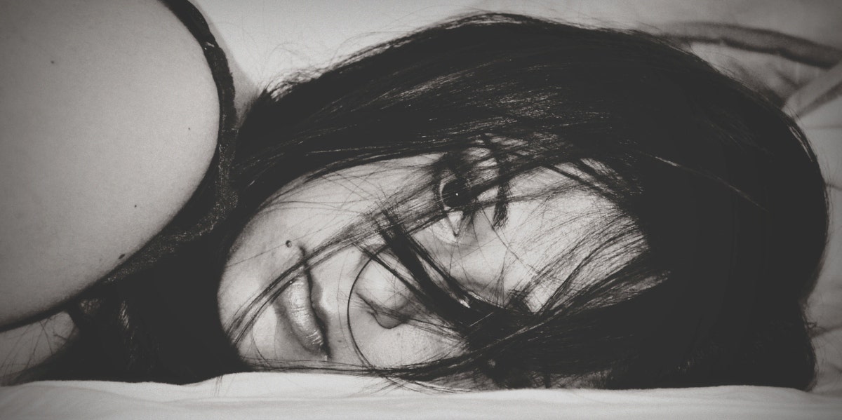 black and white photo of woman lying down