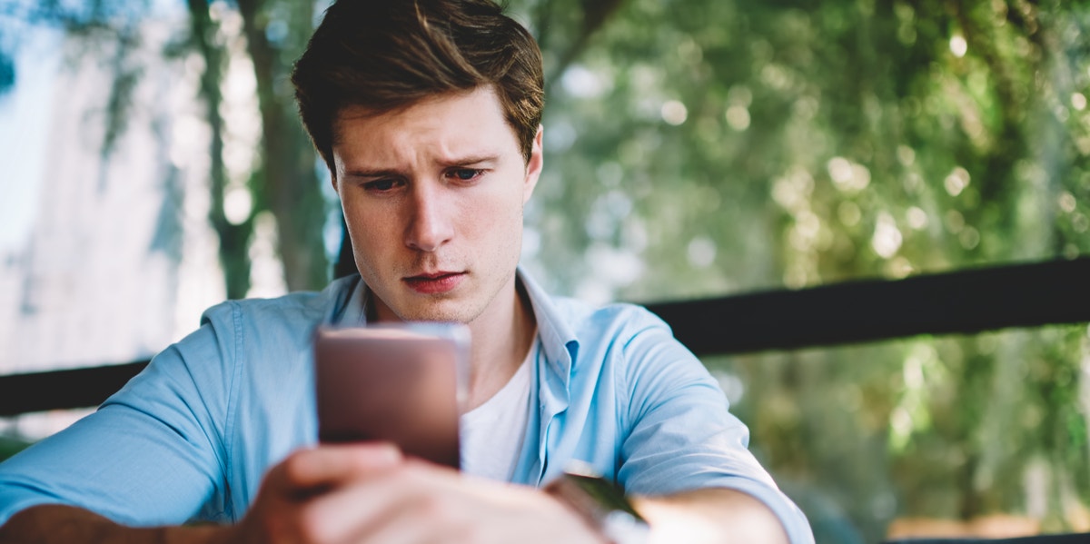 Any Guy Who Has A List Of 'Crazy Exes' Is Actually The Craziest Of 'Em All man looking at phone