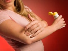 woman applying ointment