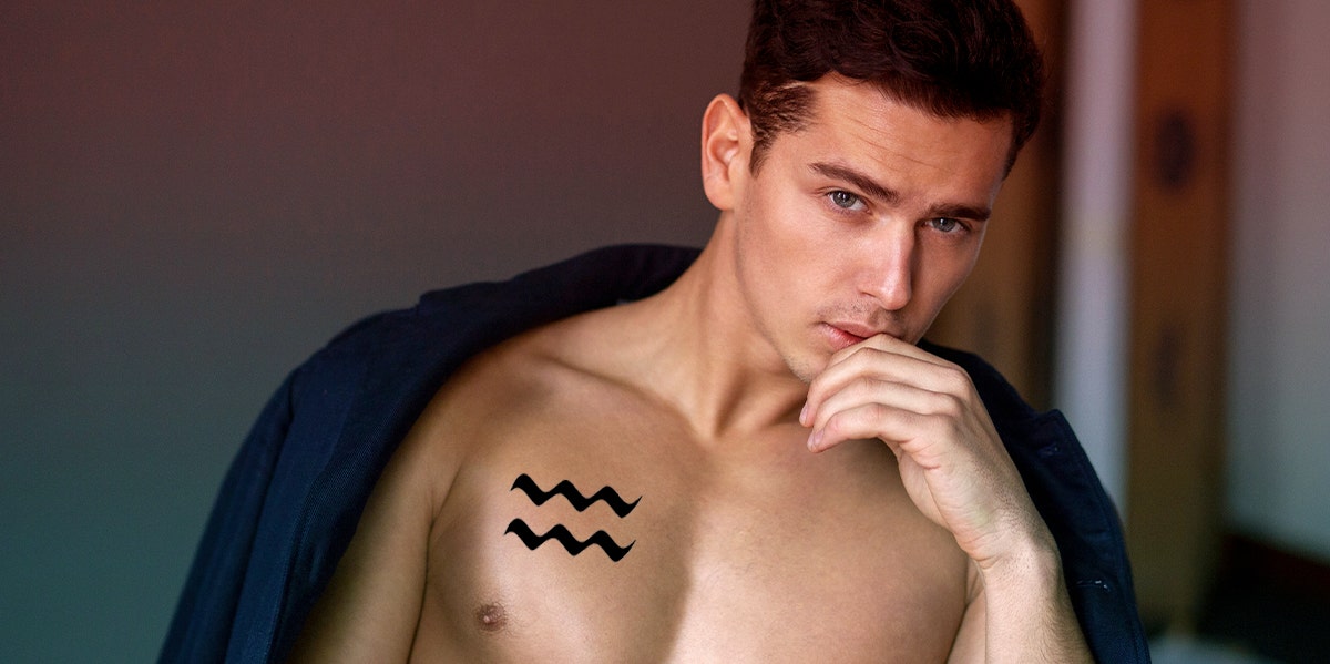man with aquarius tattoo on chest
