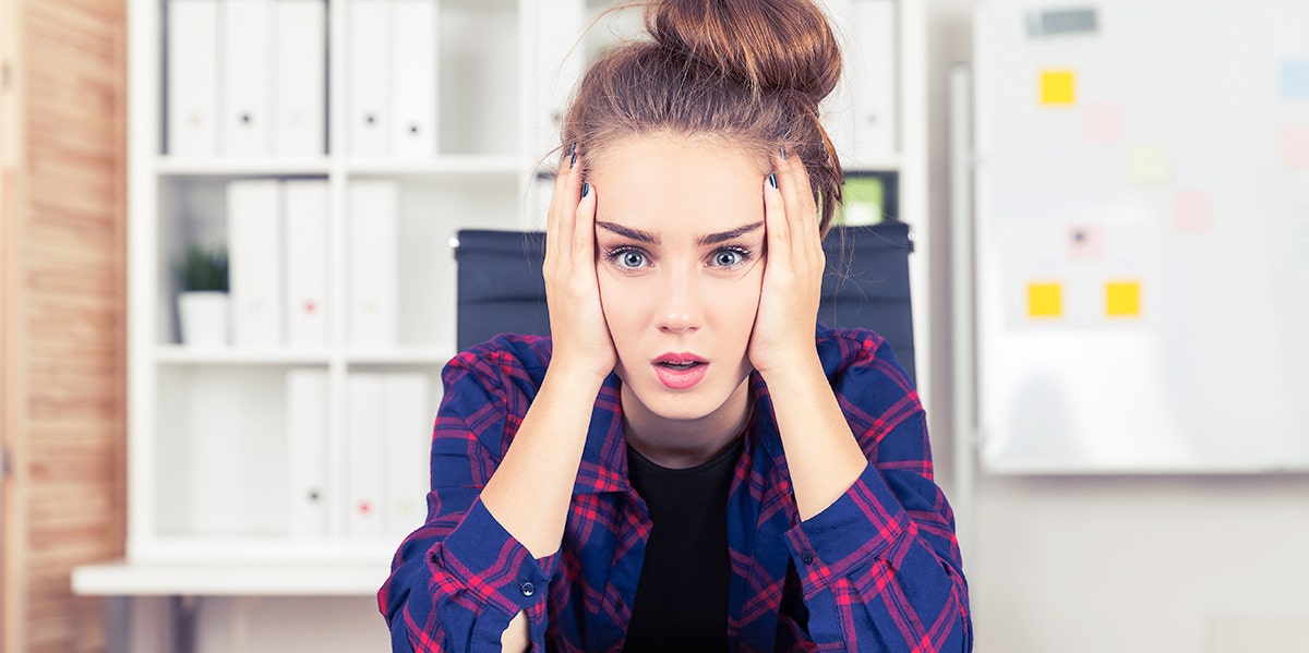 woman looking frustrated with head in her hands