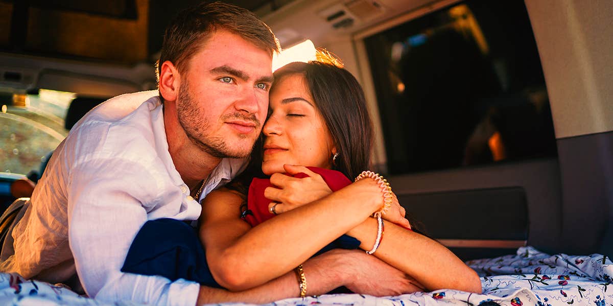 couple cuddling in back of van