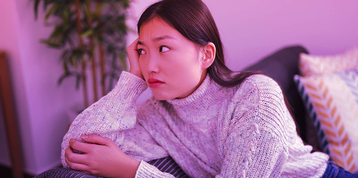 worried girl sitting on couch