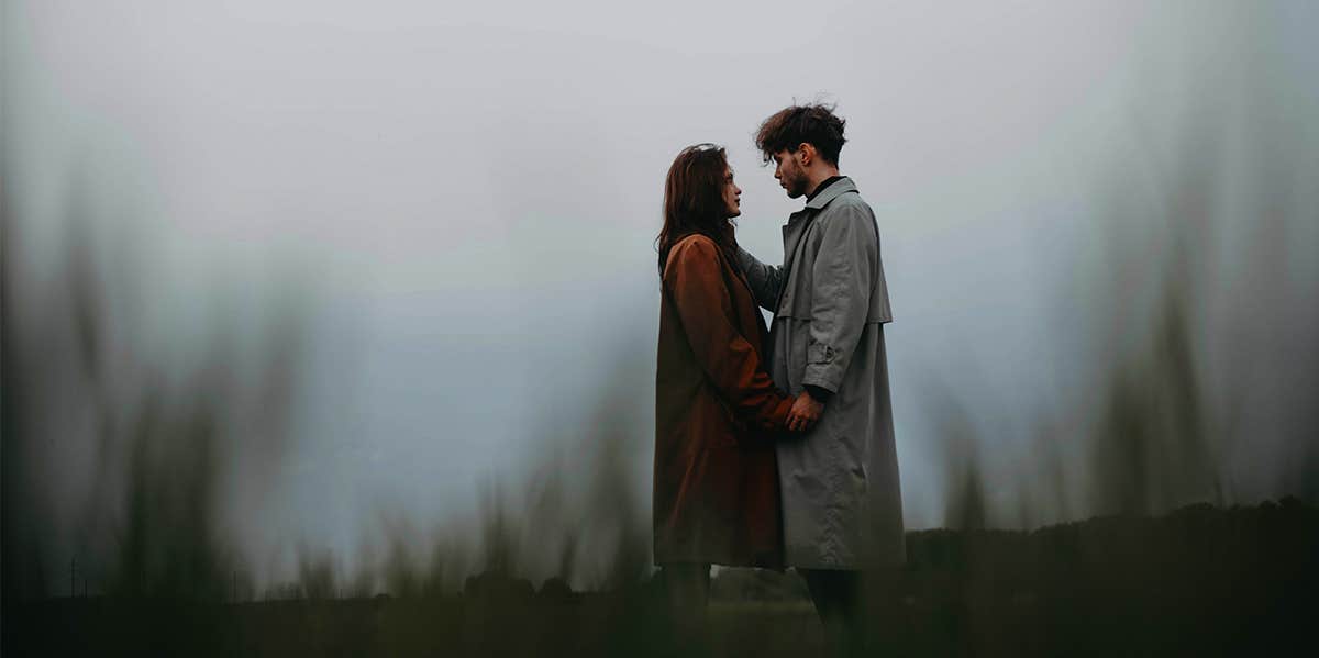 man and woman standing together in moody weather