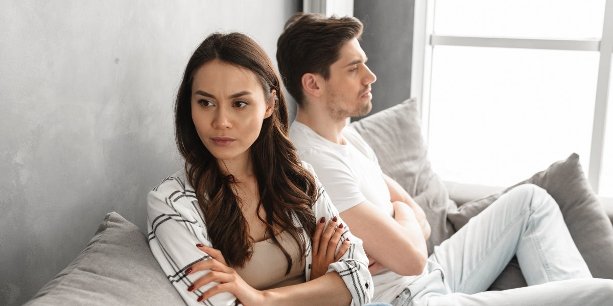 Woman Calls Out Boyfriend's Weight After He Makes A Rude Comment About Girls couple arguing and not speaking on couch