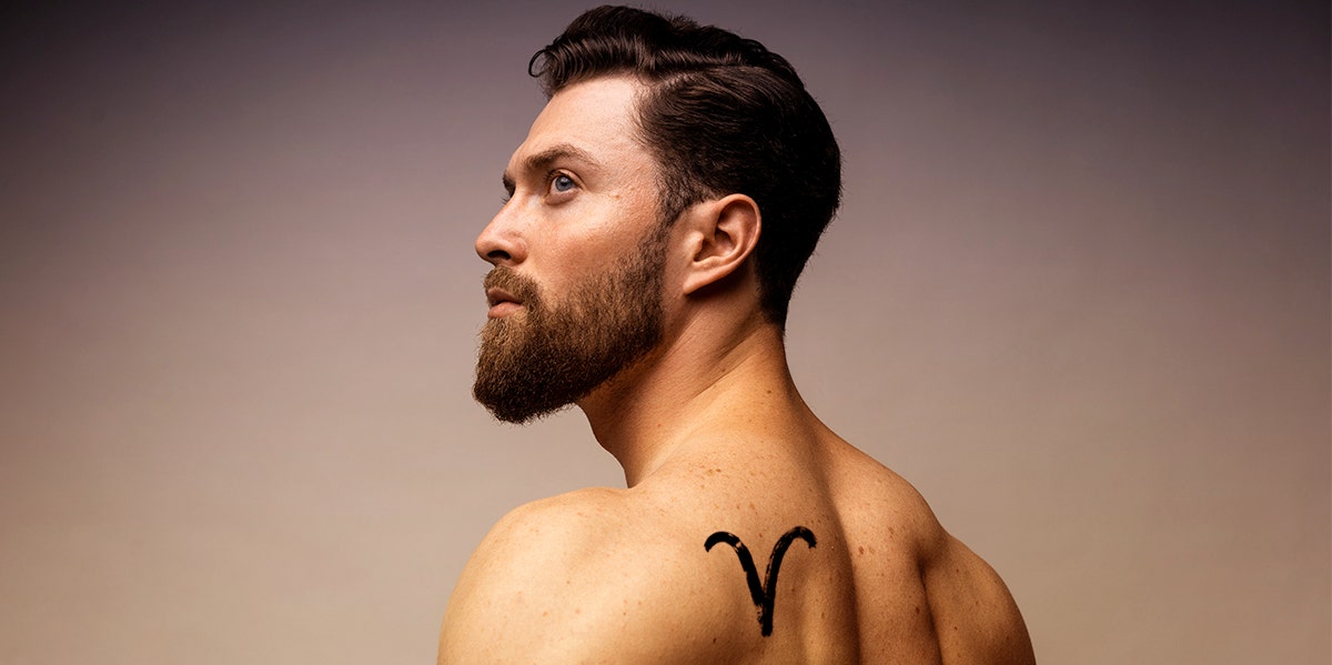 man with aries tattoo on shoulder