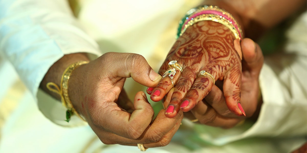 couple holding hands at indian wedding