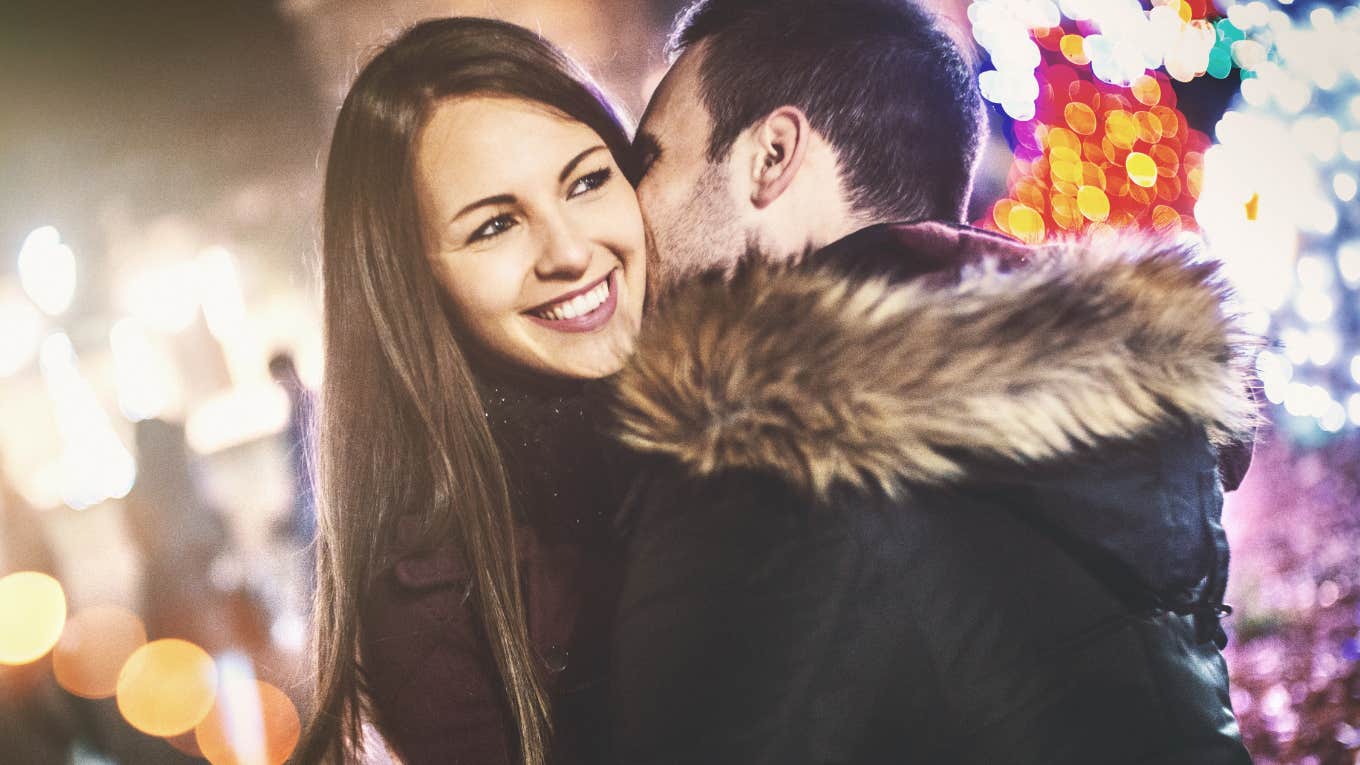 Man kissing woman on cheek 