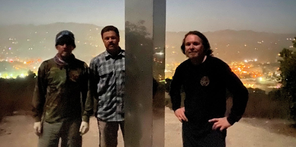 Metal Artists Who Built California's Monolith Share Their Story And Why It's Back Wade McKenzie, Jared Riddle and Travis Kenney after installing the third monolith in California