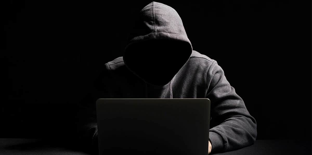 I Went Undercover On Ashley Madison To Learn Why Women Cheat anonymous man sitting in the dark on his computer