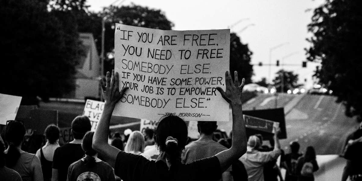 people protesting in the street with signs