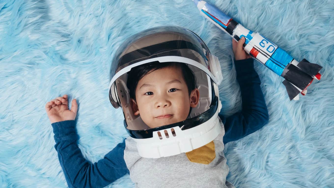 Little boy with dressed up as an astronaut smiling