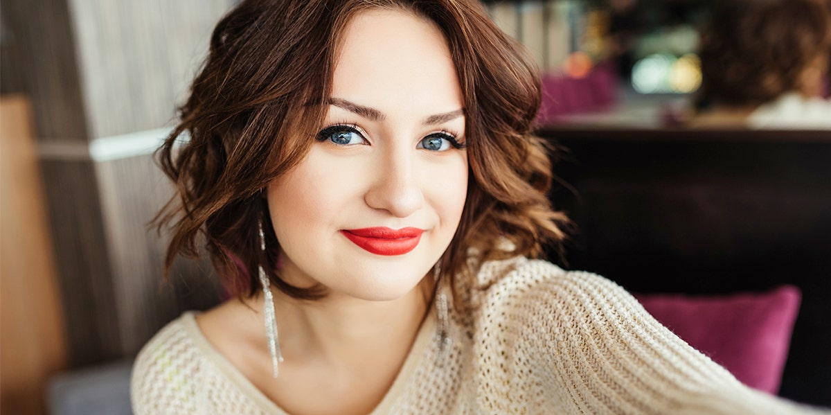 woman with red lips smiling at camera