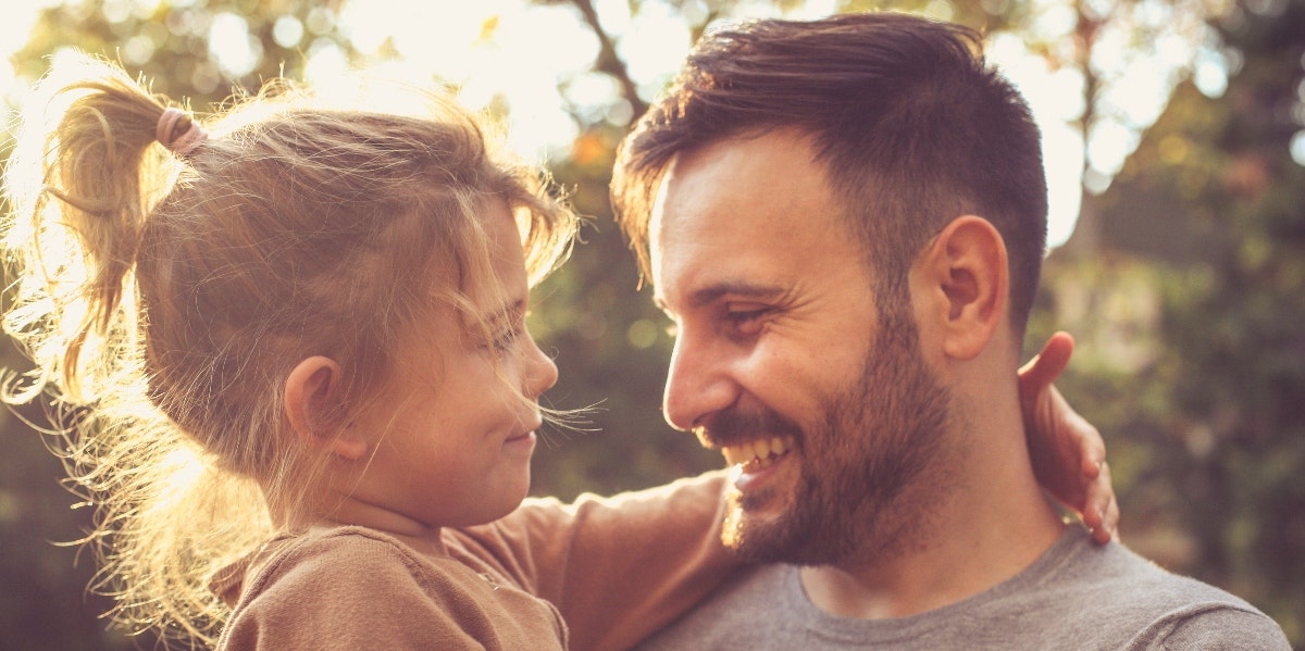 father and daughter hugging outside